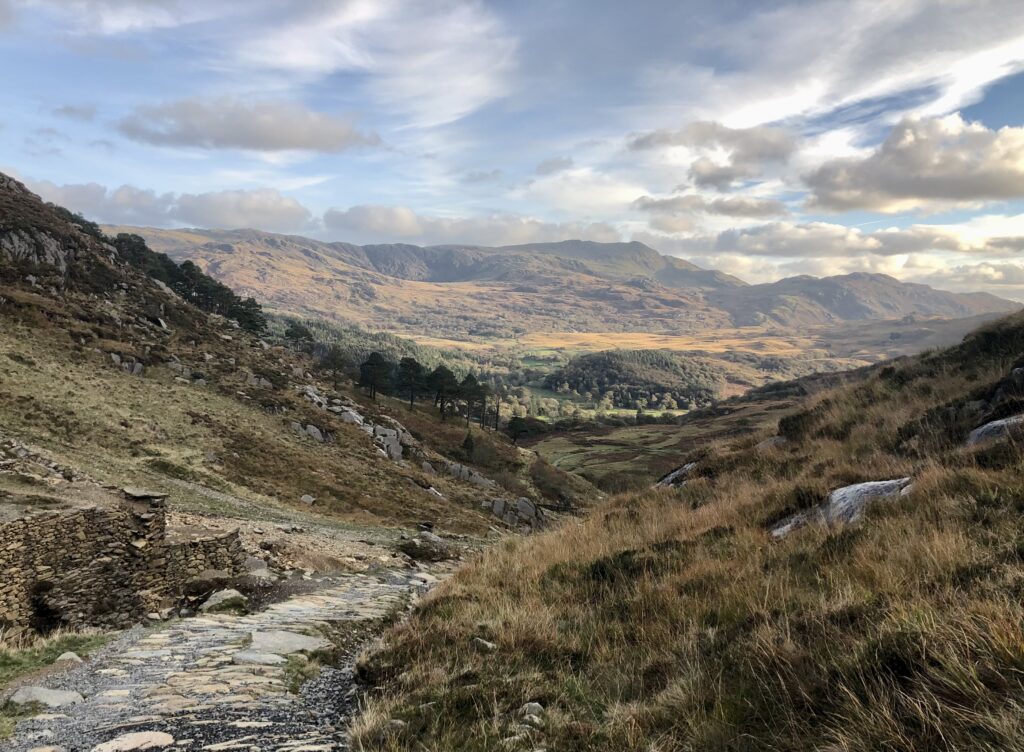 Scenic valley with mountains and clouds.