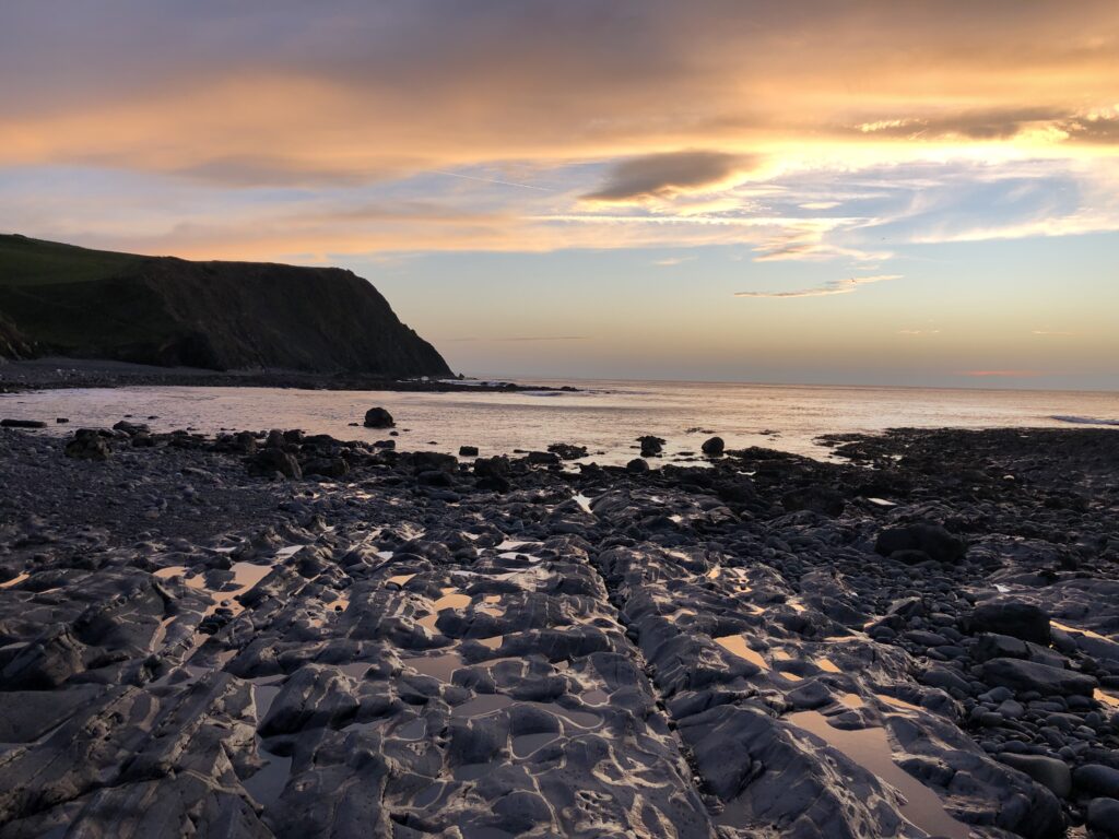 Sunset over rocky coastal landscape