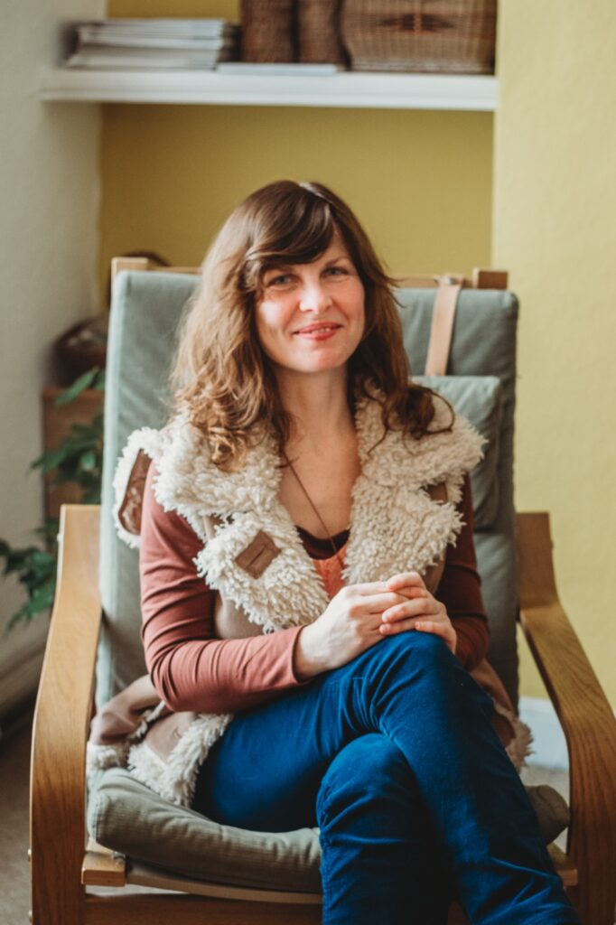 Hannah sitting in her therapy room