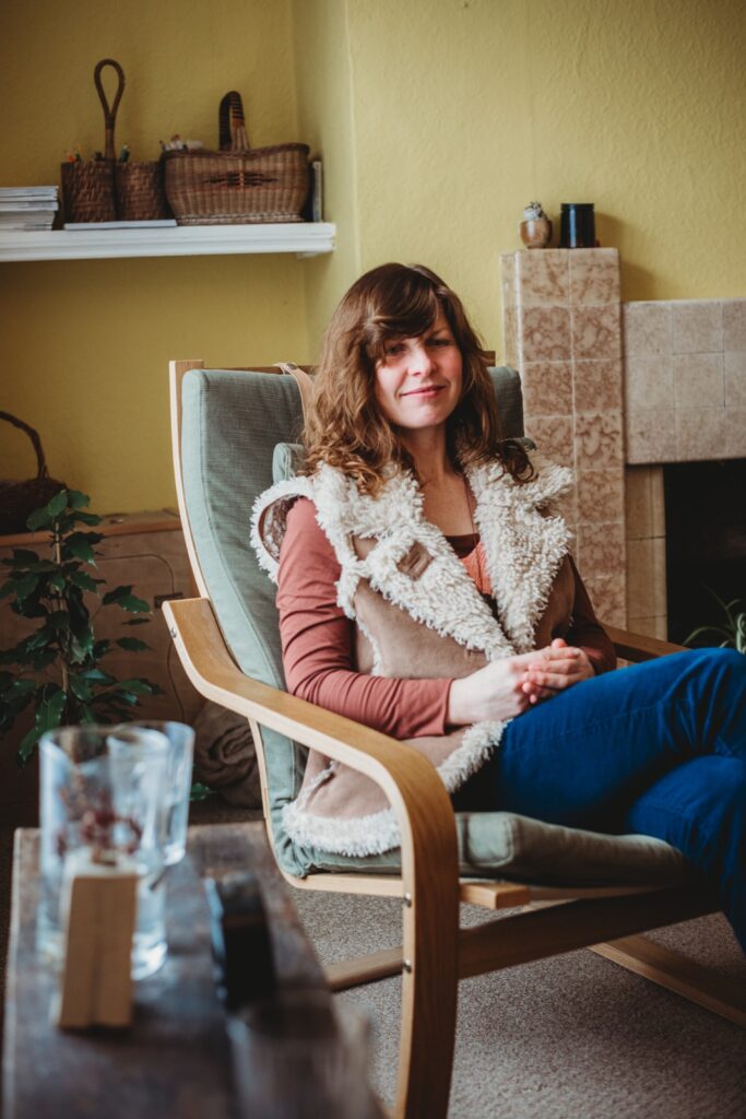 Hannah sitting in her therapy room